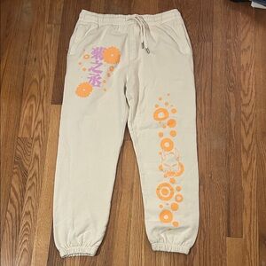 Ripple Junction Beige Joggers with Vibrant Orange Accents
